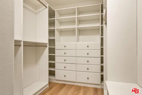 a bedroom with a bed and a lamp