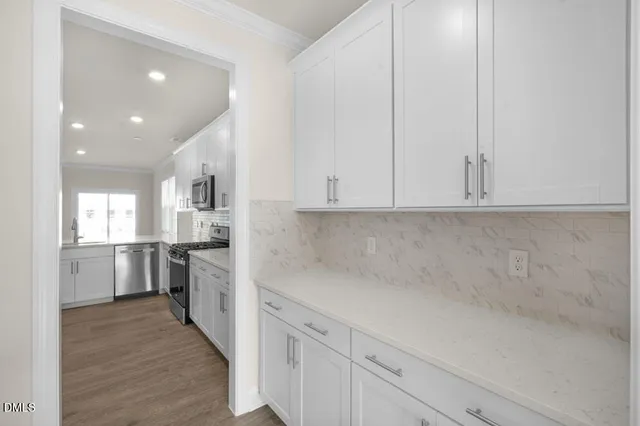 a kitchen with a refrigerator sink and cabinets