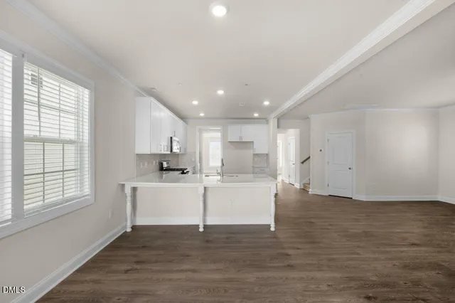 a view of kitchen with wooden floor and electronic appliances
