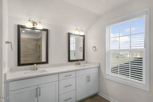 a bathroom with 2 sink and a mirror