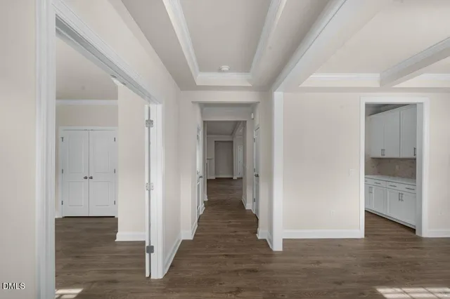 a view of a hallway with wooden floor and staircase
