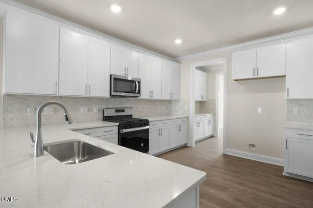 a kitchen that has a sink and a stove top oven