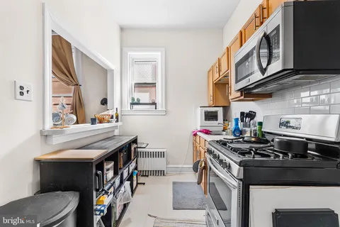 a kitchen with stainless steel appliances granite countertop a stove and a cabinets