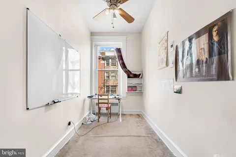 a view of entryway with workspace and windows