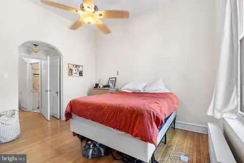 a spacious bedroom with a bed and a chandelier