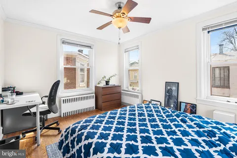 a bedroom with a bed and a desk