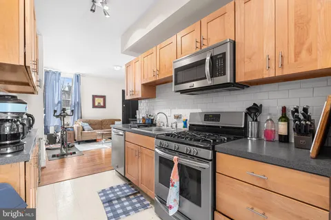 a kitchen with stainless steel appliances granite countertop a stove and cabinets