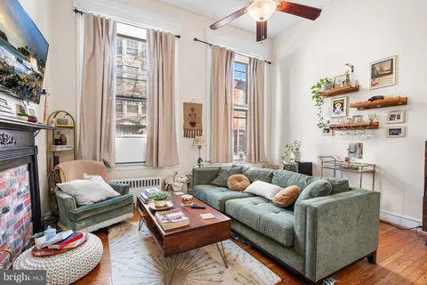 a living room with furniture and a fireplace