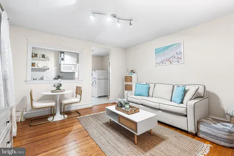 a living room with furniture a rug and a table