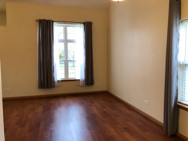 420 Kelly Court Romeoville, IL 60446 - Photo 11 of 30 a view of an empty room with wooden floor and a window