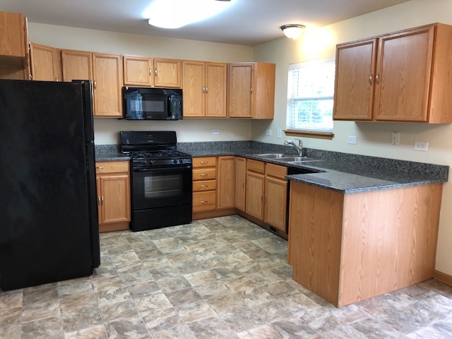 420 Kelly Court Romeoville, IL 60446 - Photo 14 of 30 a kitchen with stainless steel appliances granite countertop a stove a refrigerator and a sink