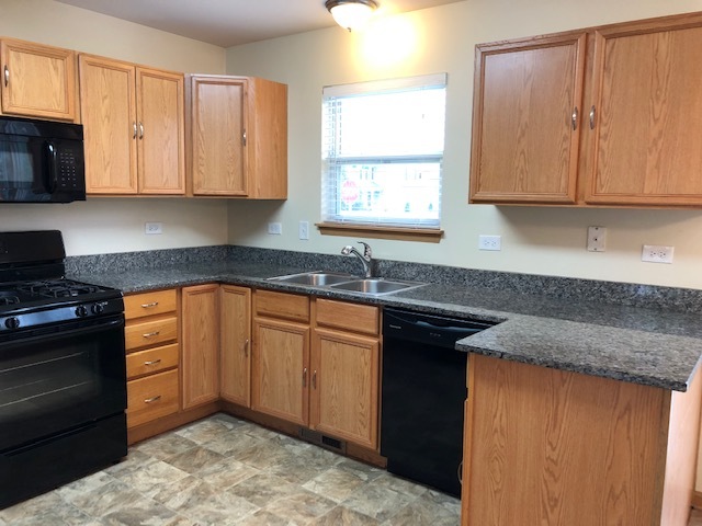 420 Kelly Court Romeoville, IL 60446 - Photo 16 of 30 a kitchen with granite countertop cabinets sink and window