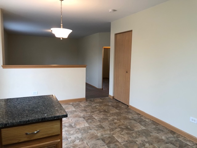 420 Kelly Court Romeoville, IL 60446 - Photo 17 of 30 a view of kitchen with granite countertop cabinets and chandelier