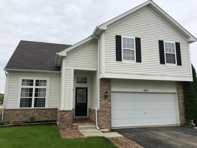 420 Kelly Court Romeoville, IL 60446 - Photo 3 of 30 a front view of a house with a yard and garage