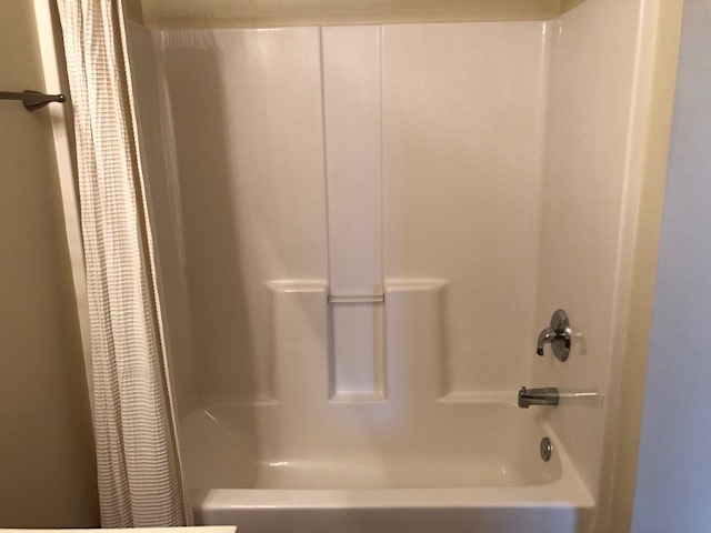 420 Kelly Court Romeoville, IL 60446 - Photo 26 of 30 a close up of a bathtub with a shower