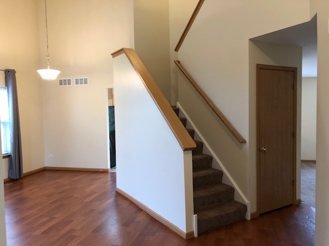 420 Kelly Court Romeoville, IL 60446 - Photo 9 of 30 a view of entryway and hall with wooden floor