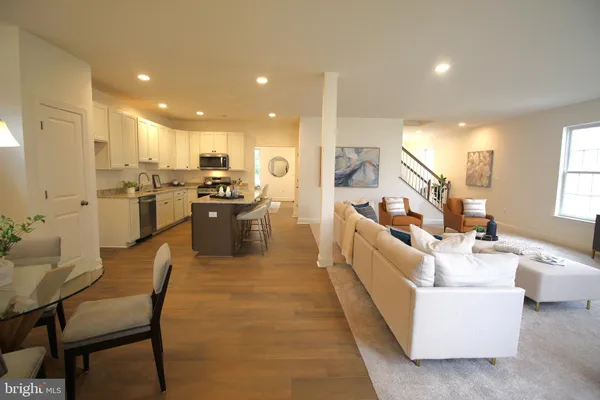 a dining room with furniture and wooden floor