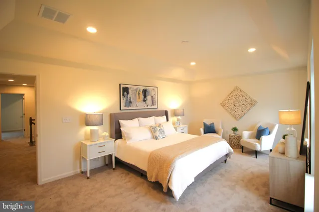 a spacious bathroom with a tub sink and mirror
