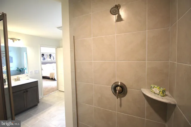 a bathroom with a double vanity sink a mirror and a bathtub