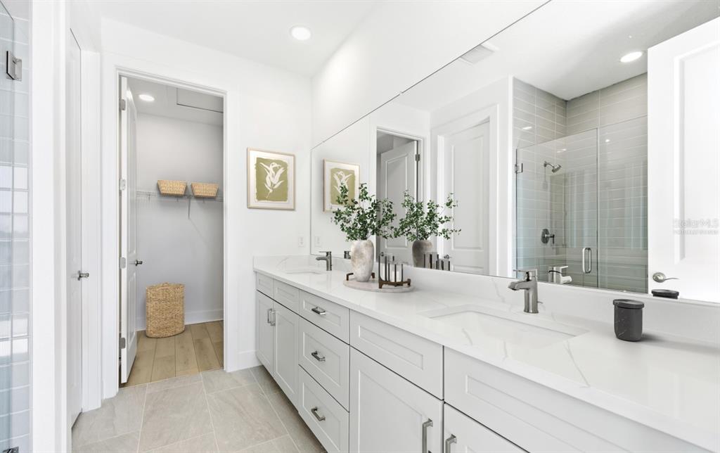 9964 Key Haven Road Seminole, FL 33777 - Photo 23 of 53 a bathroom with a double vanity sink and a mirror