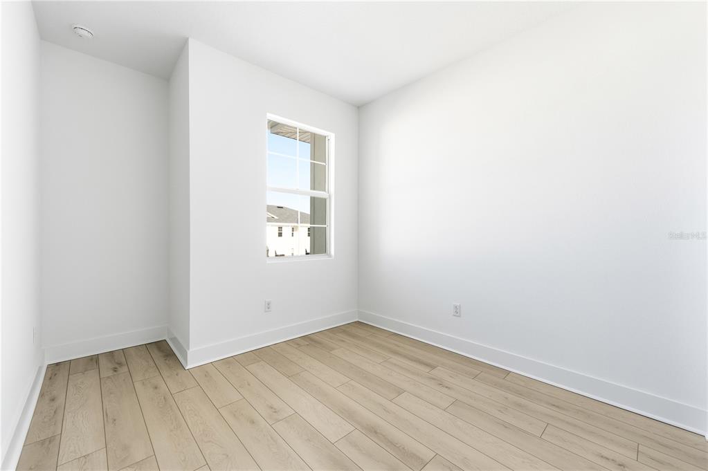 9964 Key Haven Road Seminole, FL 33777 - Photo 29 of 53 an empty room with wooden floor and windows