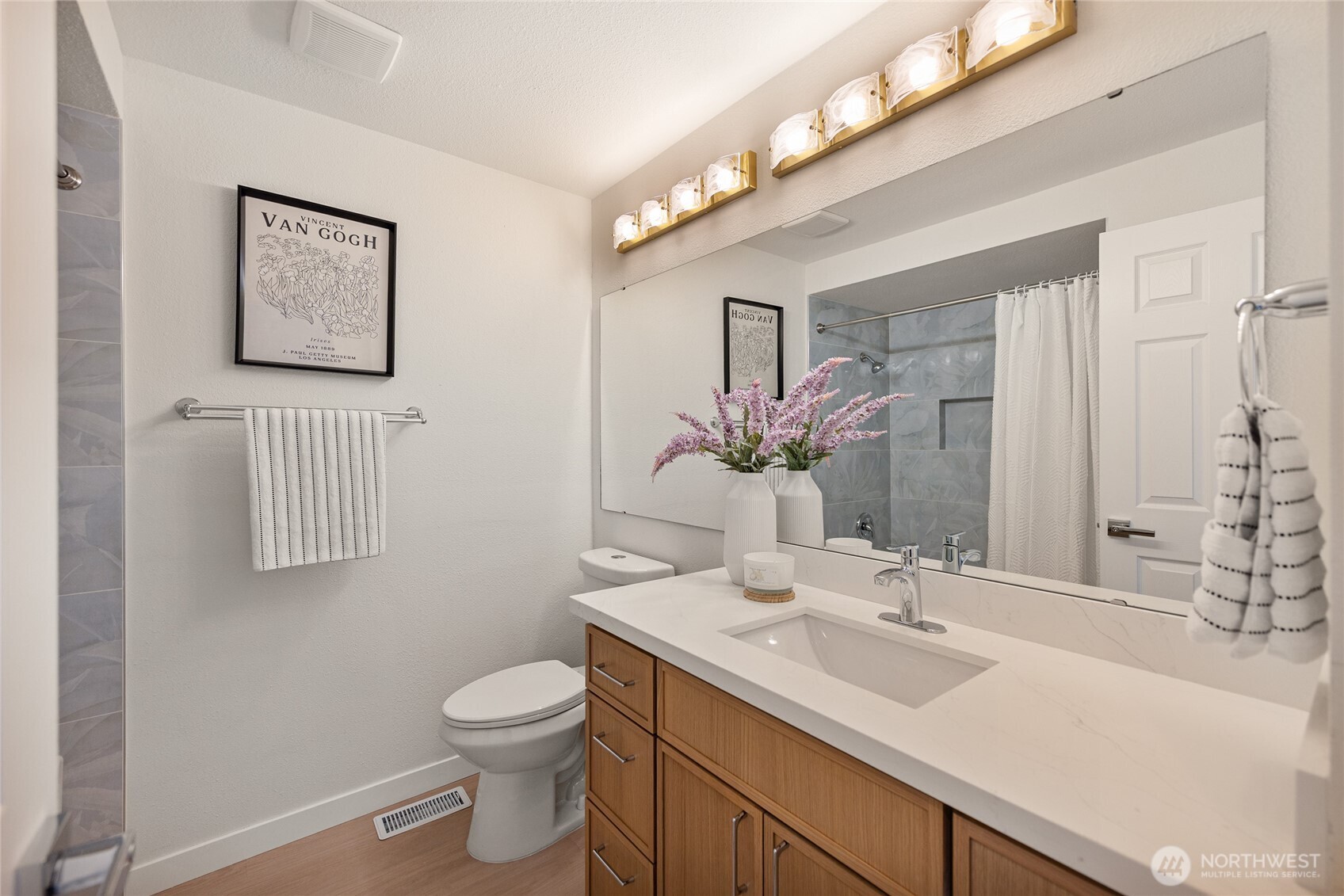 4727 155th Place Southeast Bellevue, WA 98006 - Photo 23 of 38 a bathroom with a toilet sink and mirror
