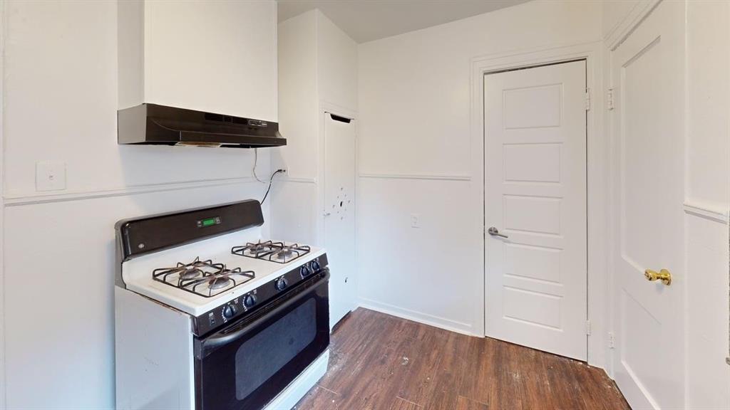 2246 Anson Road Dallas, TX 75235 - Photo 10 of 20 Kitchen area featuring a white range with black accents and an overhead exhaust hood