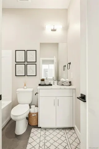 a bathroom with a sink toilet and mirror