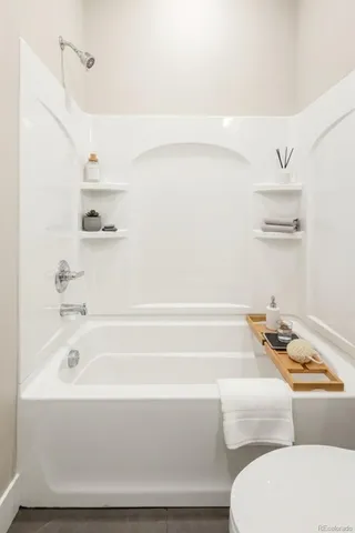 a bathroom with bathtub and dryer