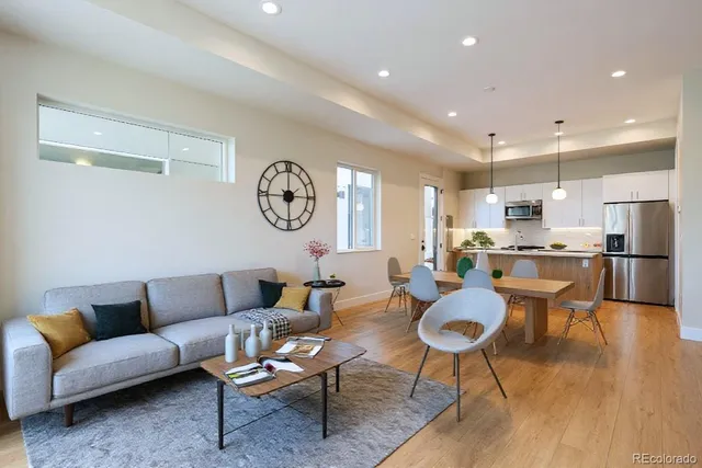 a living room with lots of furniture and kitchen view