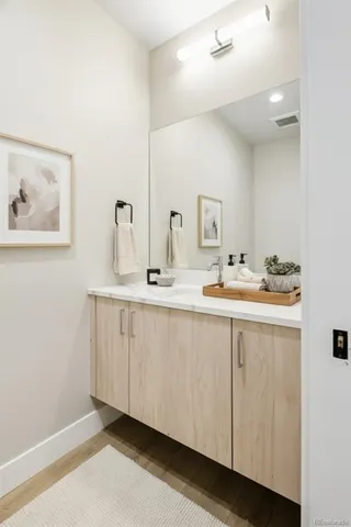a bathroom with a double vanity sink and a mirror
