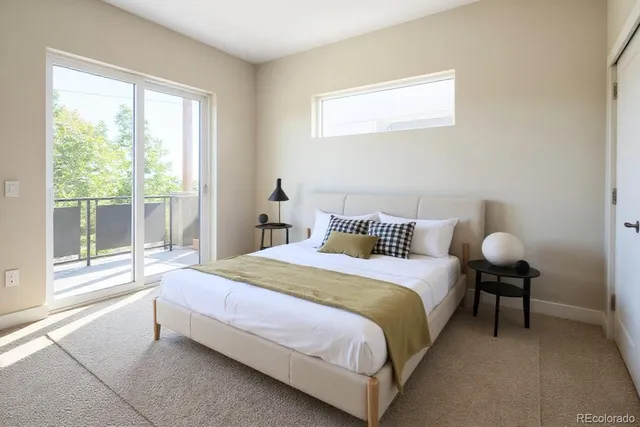 a bedroom with a bed and a lamp next to a window