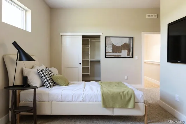 a bedroom with a bed and flat screen tv