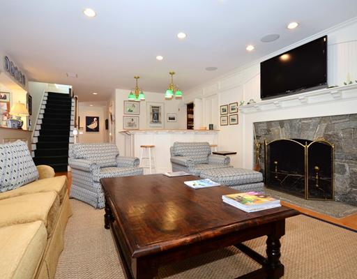 130 Long Neck Point Road Darien, CT 06820 - Photo 8 of 20 a living room with furniture a fireplace and flat screen tv
