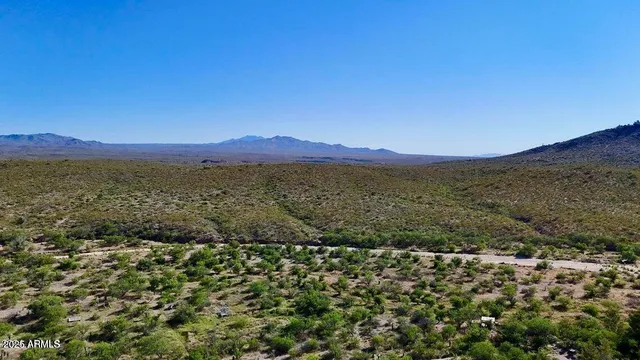 a view of mountain with lake in background