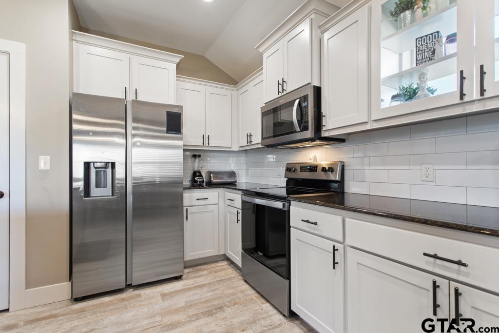 15422 Anna Lane Lindale, TX 75771 - Photo 12 of 28 a kitchen with stainless steel appliances granite countertop a refrigerator a microwave a sink and cabinets