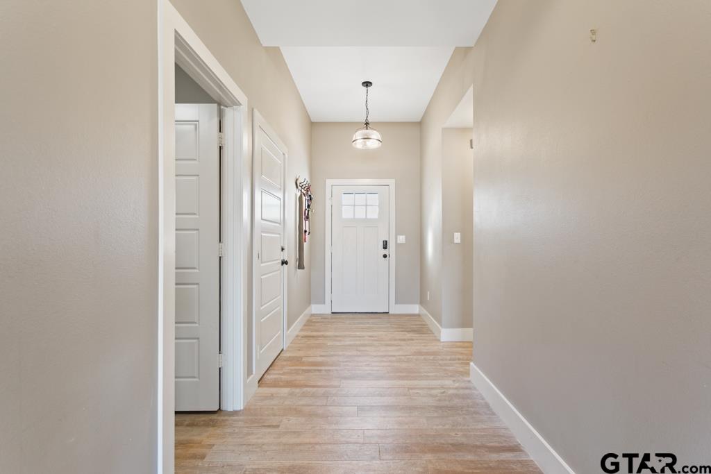 15422 Anna Lane Lindale, TX 75771 - Photo 13 of 28 a view of a hallway with wooden floor