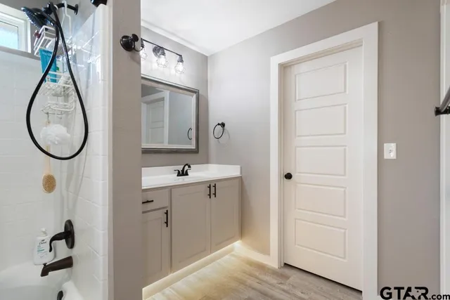 a bathroom with a mirror and a sink