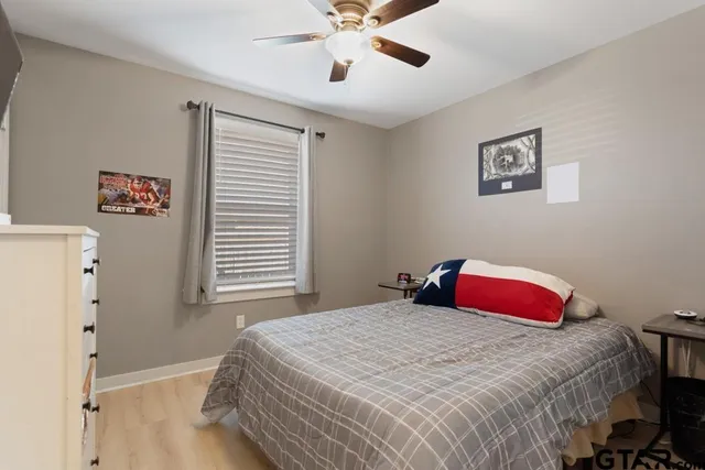 a bedroom with a bed and a chandelier
