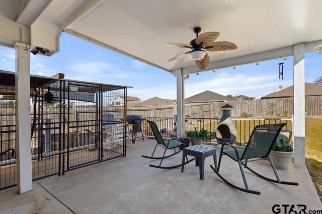 a view of a terrace with furniture and a ceiling fan