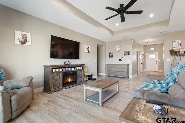 a living room with furniture a fireplace and a flat screen tv