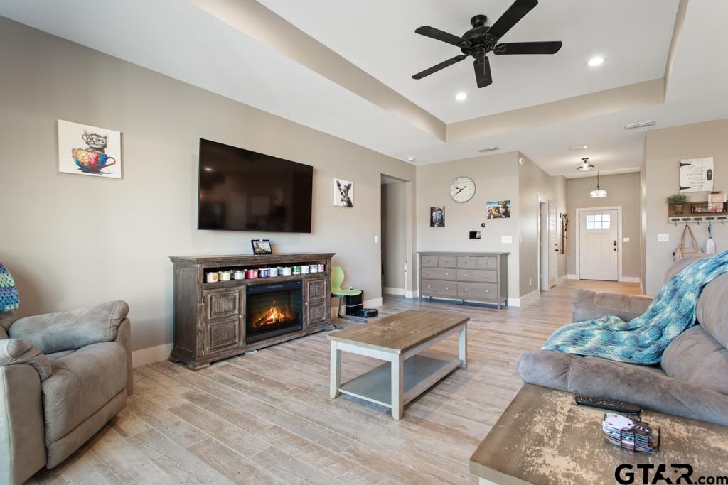 15422 Anna Lane Lindale, TX 75771 - Photo 5 of 28 a living room with furniture a fireplace and a flat screen tv