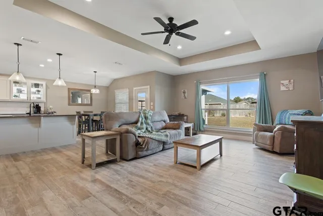 a living room with fireplace furniture and a wooden floor