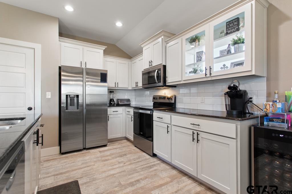 15422 Anna Lane Lindale, TX 75771 - Photo 10 of 28 a kitchen with stainless steel appliances granite countertop a refrigerator sink and microwave