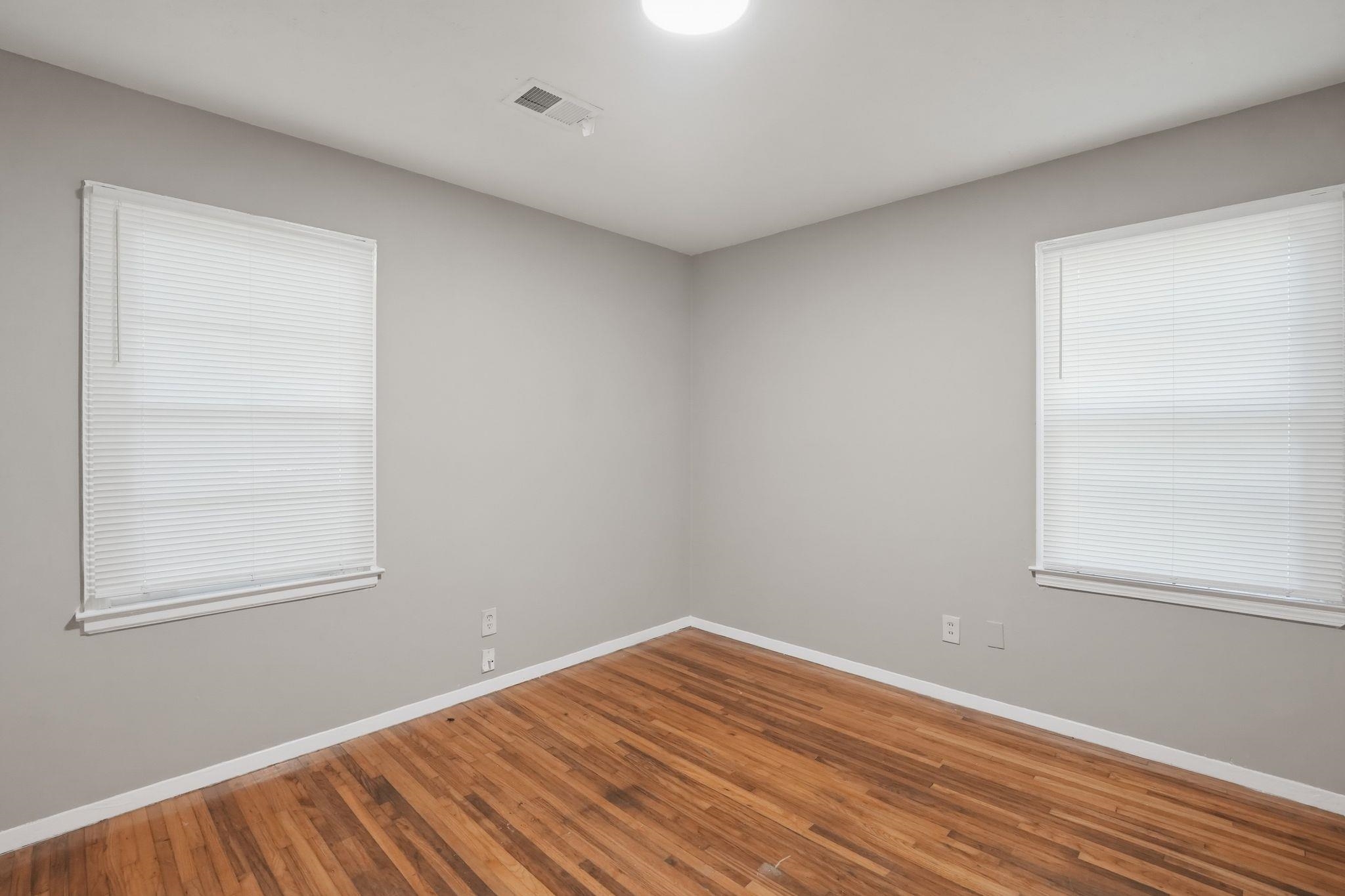 4955 Stacey Road Memphis, TN 38109 - Photo 20 of 35 Interior room featuring wood-finish flooring, light grey painted walls, and white trim