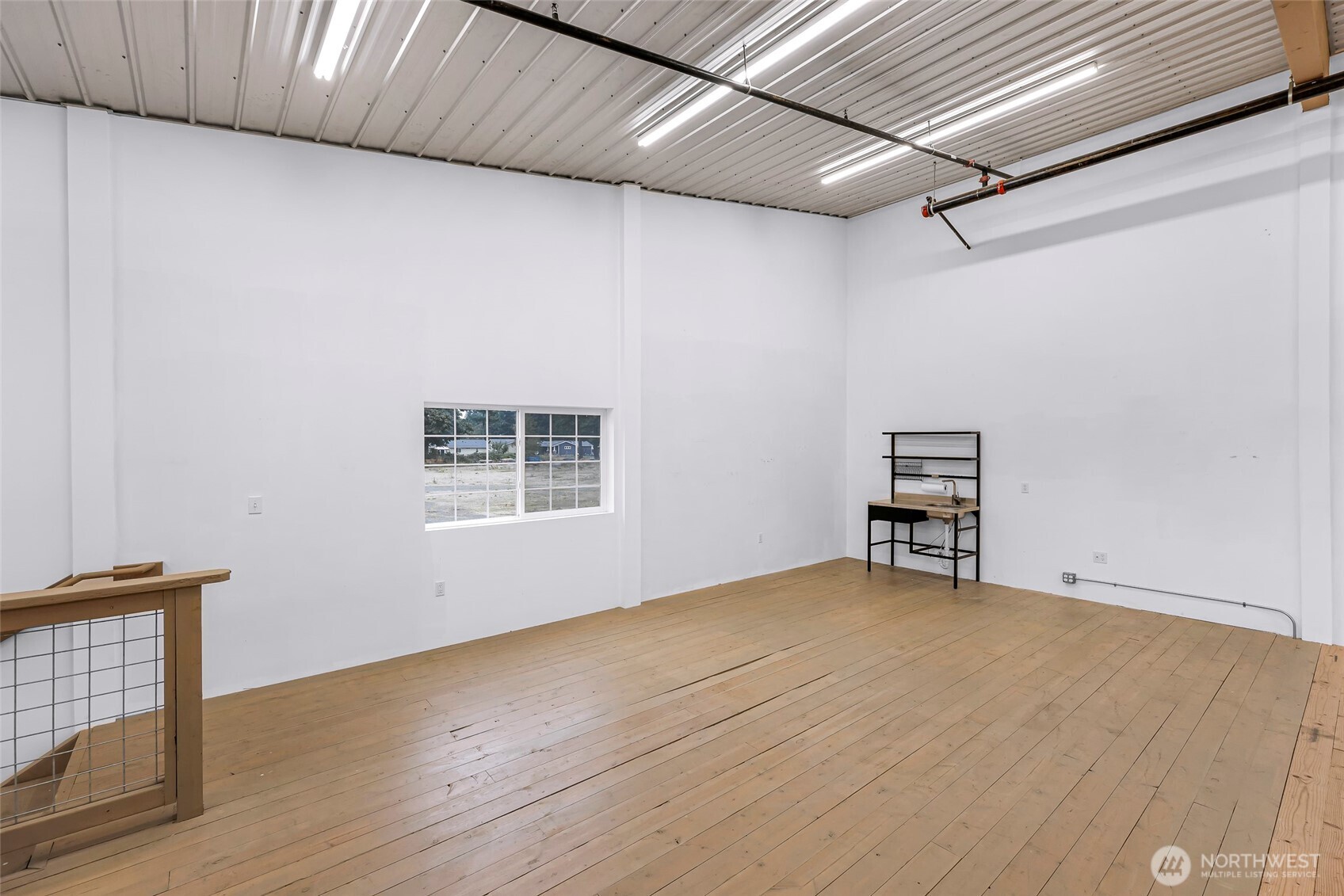 1957 Baltic Way, Unit 110 Ferndale, WA 98248 - Photo 20 of 26 a view of an empty room with wooden floor and a window