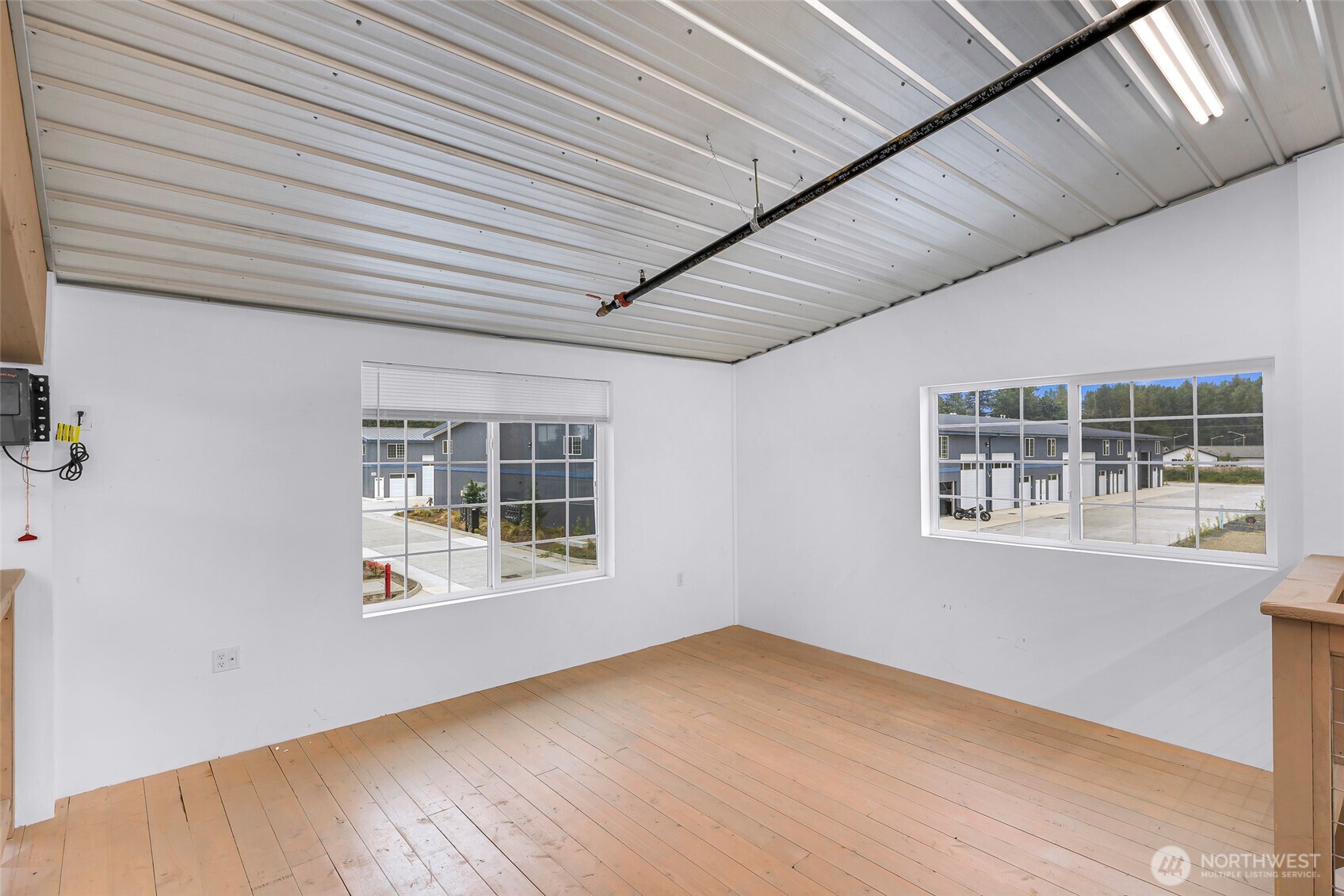 1957 Baltic Way, Unit 110 Ferndale, WA 98248 - Photo 26 of 26 an empty room with wooden floor and windows