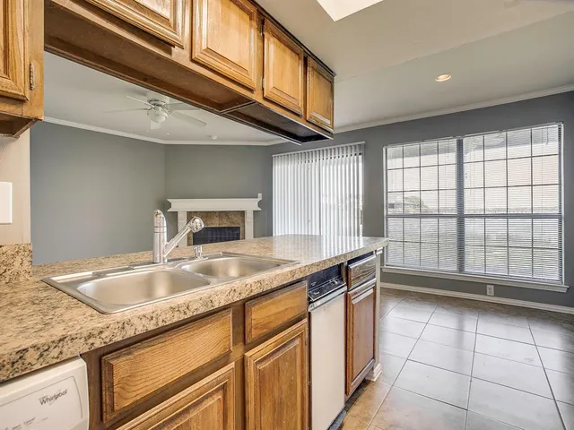 a kitchen with granite countertop a sink and a cabinets