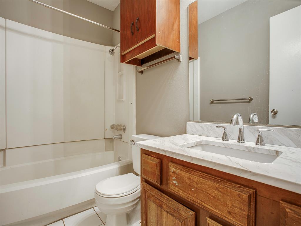 4492 Chaha Road, Unit 102 Garland, TX 75043 - Photo 15 of 40 a bathroom with a sink a toilet and a bathtub