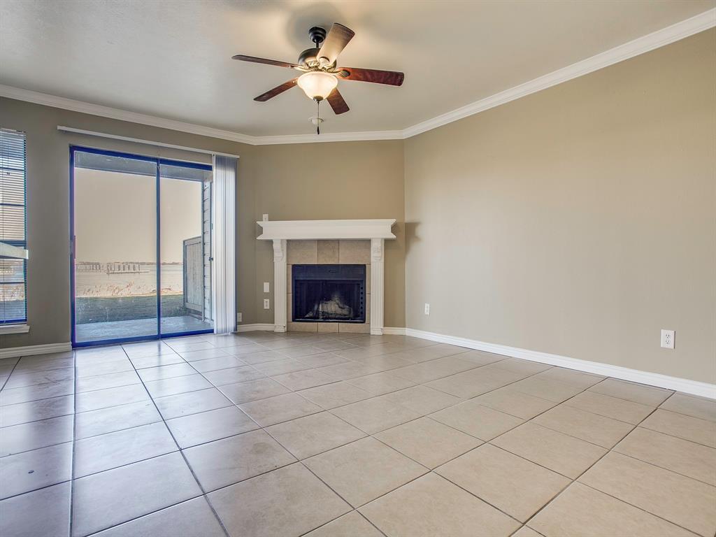 4492 Chaha Road, Unit 102 Garland, TX 75043 - Photo 25 of 40 an empty room with fireplace and fan